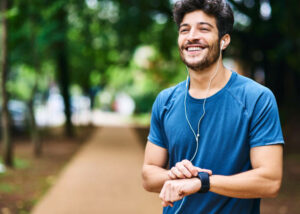 Shot of a sporty young man checking his watch while exercising outdoors